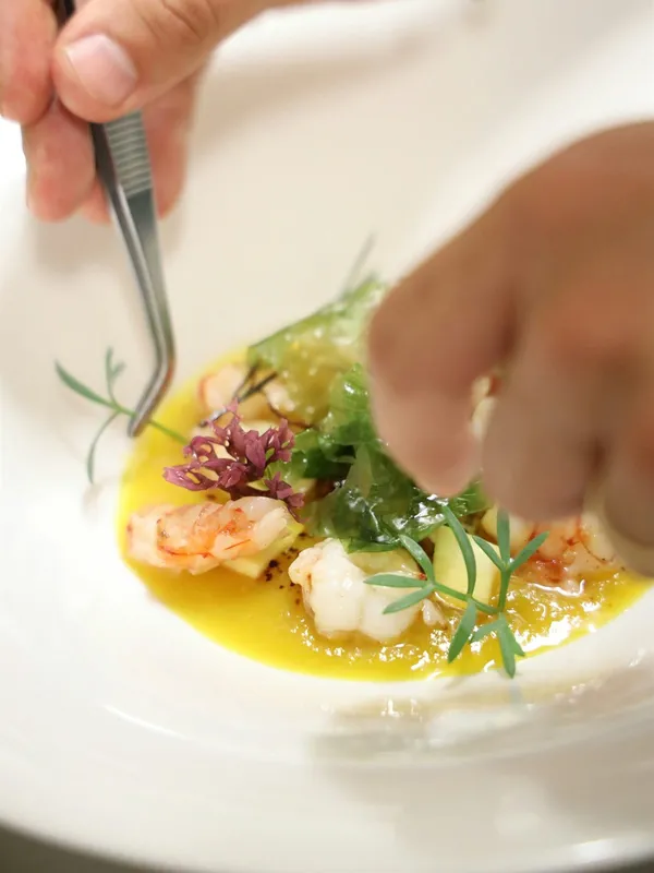 Chef carefully preparing a dish